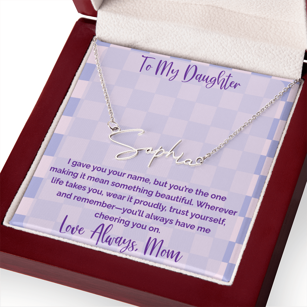Silver signature name necklace reading “Sophia” in an open wooden gift box with a lavender checkered “To My Daughter” message card from Mom.