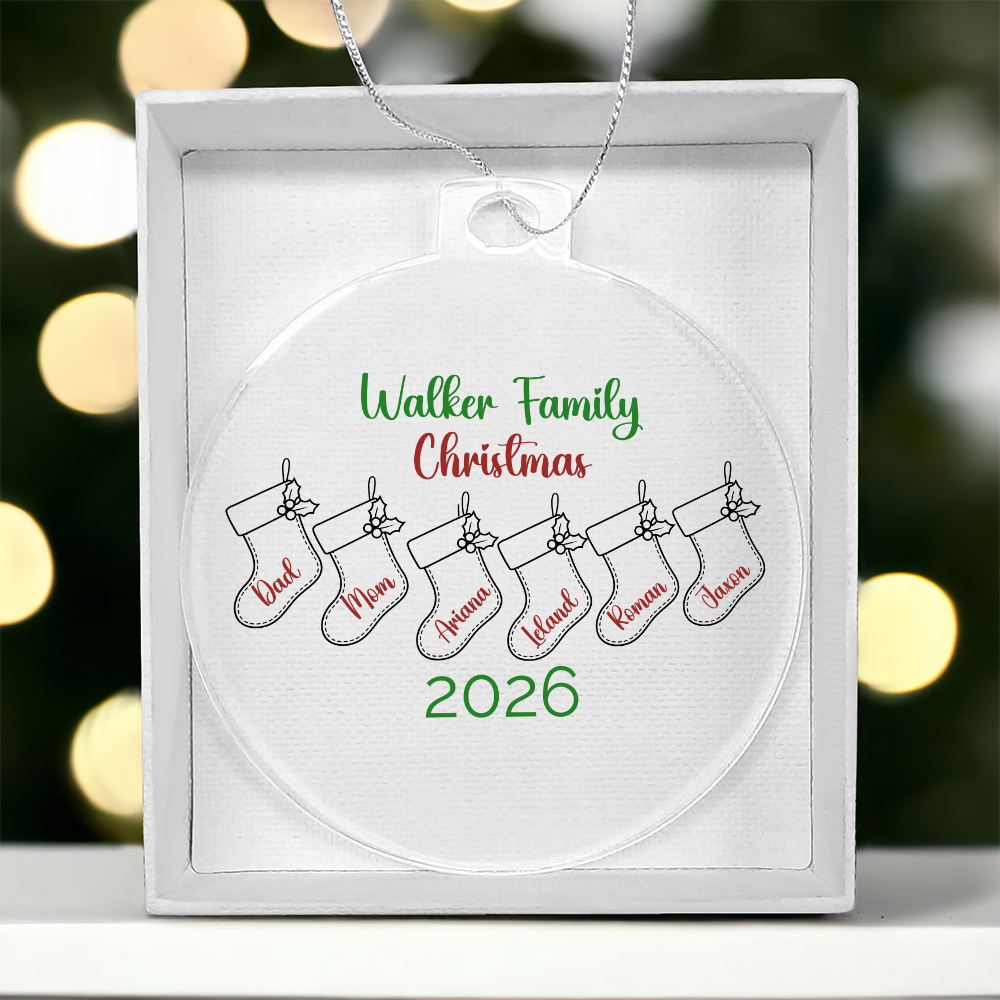 Personalized acrylic Christmas ornament with a family name, six illustrated stockings labeled with names, and the year 2026.