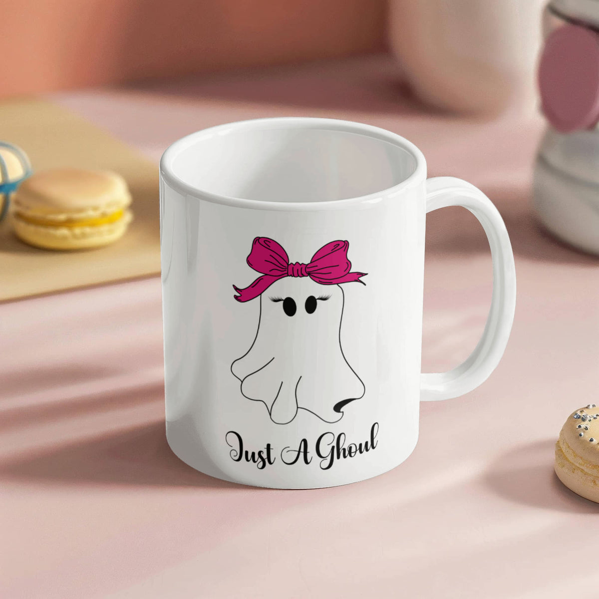 White Just a Ghoul ceramic mug featuring a cute ghost with eyelashes and a bright pink bow.